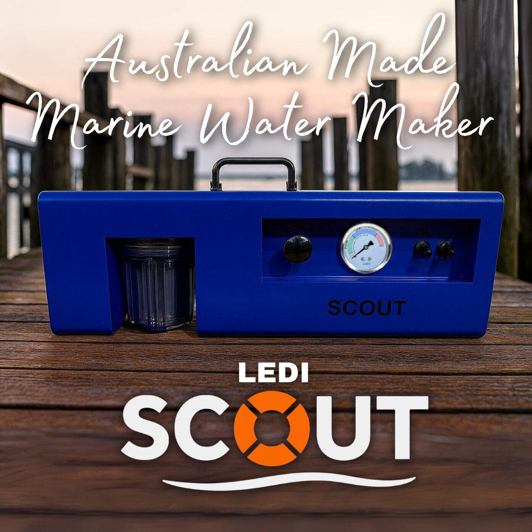 Blue marine water maker labeled 'LEDI Scout' on a wooden surface with a blurred outdoor background.