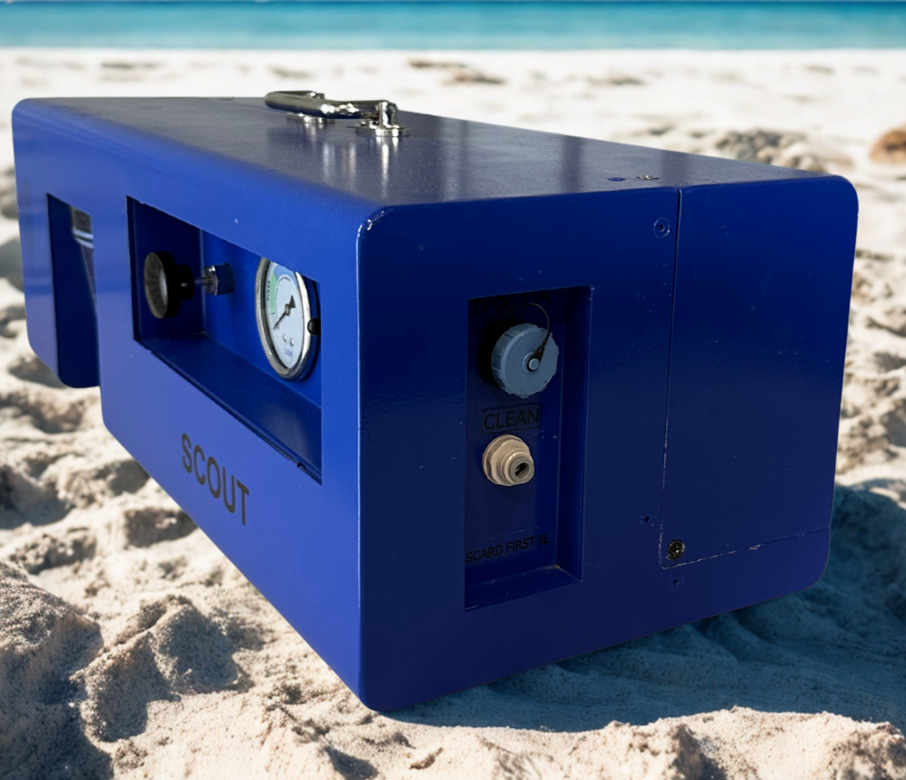 Blue device labeled 'SCOUT' on a sandy beach